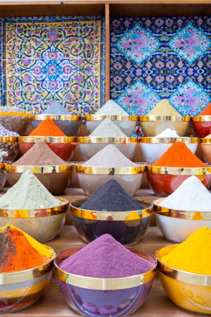 Traditional spices market. Pots and wooden tubs stand in row with colorful tea, spices, fruits, roots, flowers. Street bazaar. Dubai, UAE. Vertical photoの写真素材