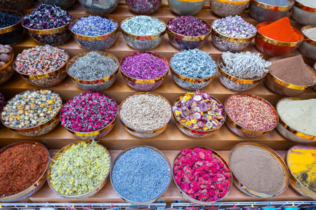 Traditional spices market. Pots and wooden tubs stand in row with colorful tea, spices, fruits,...