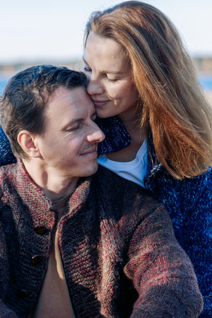 Portrait happy beautiful couple in love enjoying autumn picnic in autumn park. Vertical photo. High quality photoの写真素材