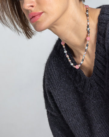 Neck of young woman close-up on grey background. Studio photography. Vertical photo. High quality photoの写真素材