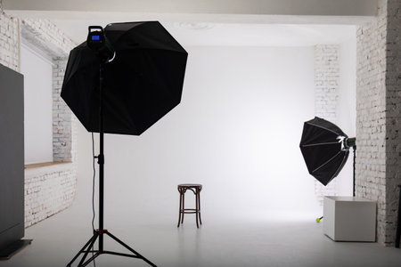 Clear white cyclorama. Light background with with professional lighting equipment. Plain wall empty...