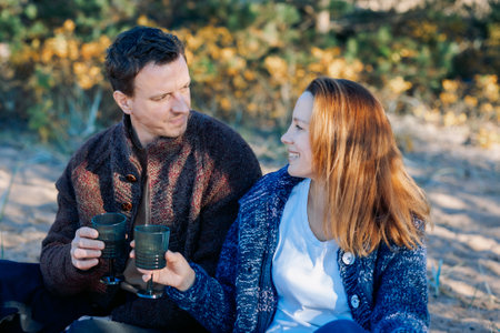 Portrait happy beautiful couple in love enjoying autumn picnic in autumn park. High quality photoの写真素材