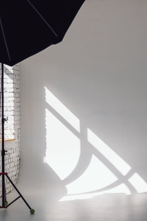Clear white cyclorama. Light background with with professional lighting equipment. Plain wall empty photo studio. Vertical photo.の写真素材