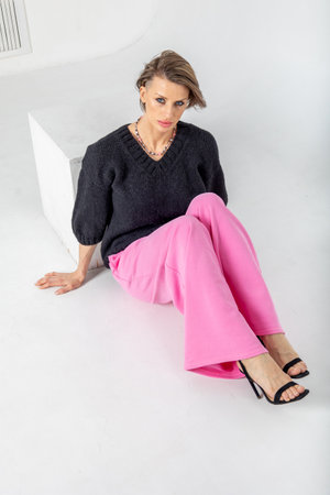 Portrait of a woman posing in a studio. Vertical photo.の写真素材