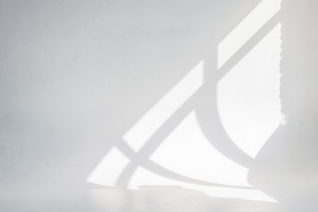 Clear white cyclorama. Light background with sun light and shadows. Plain wall empty photo studio. . High quality photoの写真素材