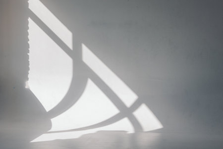 Clear white cyclorama. Light background with sun light and shadows. Plain wall empty photo studio. . High quality photoの写真素材