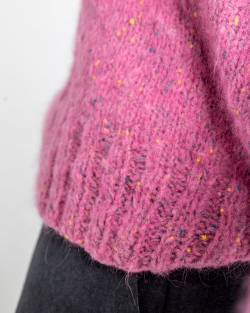 Portrait beautiful woman of model appearance. Girl in pink jumper, black trousers on grey background. Vertical photo. High quality photoの写真素材
