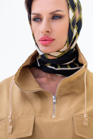 Portrait of young woman in scarf close-up on white background. Studio photography. Vertical photo. High quality photoの写真素材