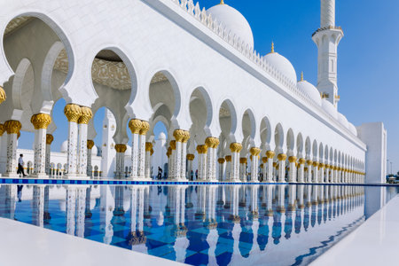 View of Sheikh Zayed Grand Mosque in Abu Dhabi made of white marble with flowers made of precious stones in design and beautiful reflections in water. High quality photoの写真素材