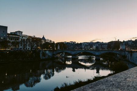 Rome in the evening. Panoramic view of Castel SantAngelo and Bridge in Rome with reflection in Tiber river.の写真素材