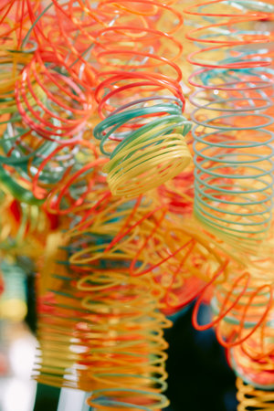 Lots of bright colorful spirals. Abstract blurred background with selective focus on waves. Vertical...