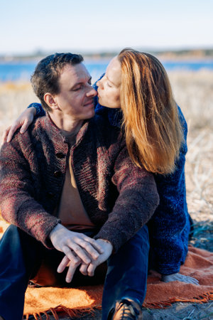 Portrait happy beautiful couple in love enjoying autumn picnic in autumn park. High quality photoの写真素材