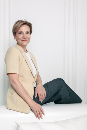 Portrait of happy woman. Confident, successful mature woman on light gray background. Looking at camera. High quality photoの写真素材