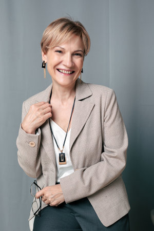 Portrait of happy woman. Confident, successful mature woman on light gray background. Looking at camera. High quality photoの写真素材