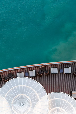 Top view of sea and water of sailing ship. Lounge promenade deck on cruise liner, vertical photo.
