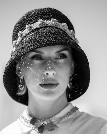 Portrait of beautiful girl in summer hat close-up, black and white photo. Retro styling woman. High quality photoの写真素材