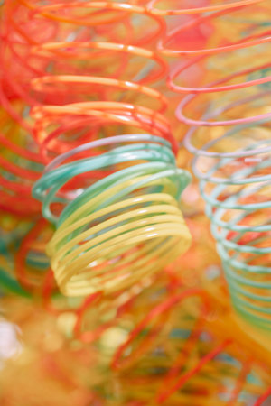 Lots of bright colorful spirals. Abstract blurred background with selective focus on waves. Vertical photoの写真素材