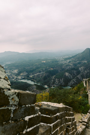 Aerial view of Simatai section of Great Wall of China in its original, un-restored state. Watchtowers perched on mountain peaks, China, Beijing. Vertical photo. High quality photoの写真素材