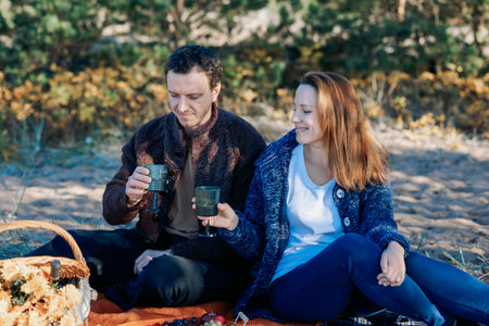 Portrait happy beautiful couple in love enjoying autumn picnic in autumn park. High quality photoの写真素材