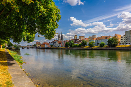 Panoramic view on beautiful Stone Bridge, Cathedral and Old Town. River Danube with colorful reflection, Regensburg, Bavaria, Germany. High quality photoの写真素材