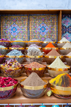 Traditional spices market. Pots and wooden tubs stand in row with colorful tea, spices, fruits, roots, flowers. Street bazaar. Dubai, UAE. Vertical photoの写真素材
