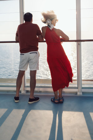 Couple in love on cruise ship. Man and woman in love enjoying their romantic vacation. Vertical photo. High quality photoの写真素材