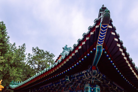 Decorative eaves of historic in Summer Palace architecture highlighting layered roof structure vivid colors craftsmanship and cultural heritage context, Beijing, Chinaの写真素材