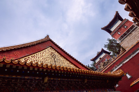 Beijing, China - October 5, 2025: Traditional Summer Palace gate with orange glazed roof tiles,...