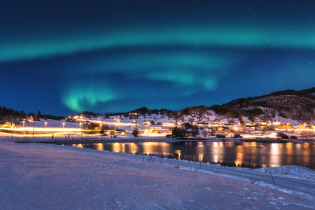 Northern lights, Aurora borealis in night sky over Gausvik, Lofoten Islands, Norway. Scenic winter landscapeの写真素材