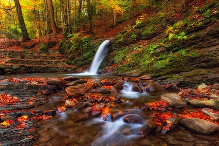 Amazing nature autumn landscape with waterfall in the forestの写真素材