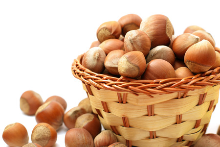 hazelnut in wicker basket isolated on white background.の写真素材