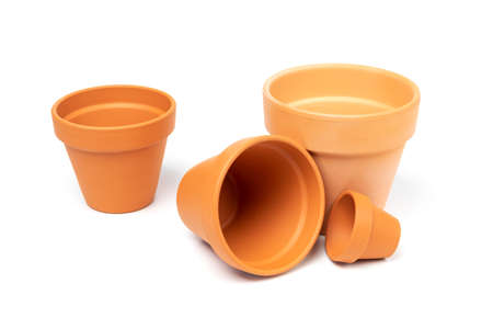 Empty ceramic pots in various sizes. Isolated on white background. Gardening concept, indoor garden