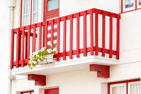Colored window and balcony in typical small wooden house with colorful stripes in Costa Nova, Aveiro, Portugal. Detail of the house in famous resort Costa Nova.の写真素材