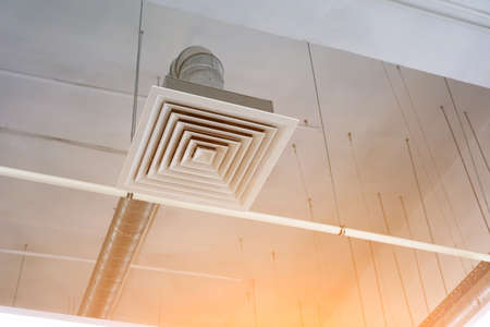 Pipe of the supply and exhaust ventilation system on the ceiling of a commercial room or warehouse.の写真素材