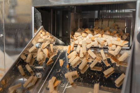 Automated bread slicing. The process of making croutons. Preparation of Russian national snack.の写真素材