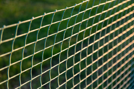 Use of rolled plastic rolls for lawn fencing. Soft focusの写真素材