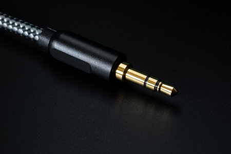 gold-plated TRS connector for sound transmission, audio cable for excellent sound quality on black background. Shallow depth of field.の写真素材