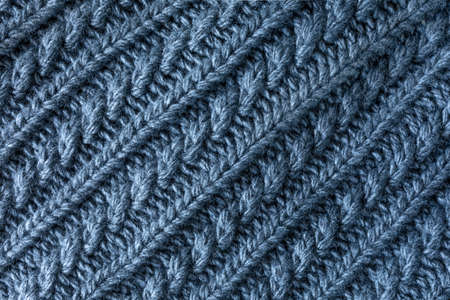 gray woven fabric texture background. sample of gray wool knitting. Figured knitting for a product....