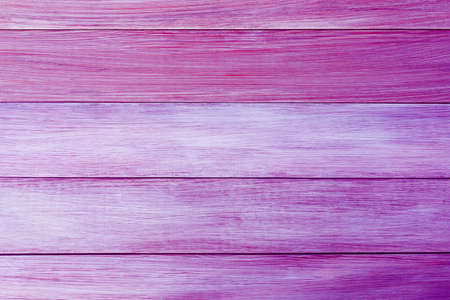 The background of wooden boards painted in the new trend colors of 2022 year Pacific Pink and Very Peri. Texture top view. Blog backdrop for text design. Abstract wallpaper, wooden surface.Copy spaceの写真素材