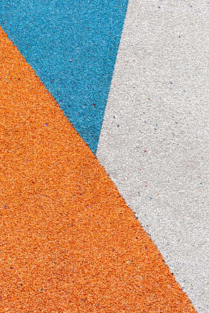 Special rubber coating for the playground or sports activity. Junction of multicolored pieces of floor covering made of recycled materials. Padded floor covering with rubber granules.の写真素材