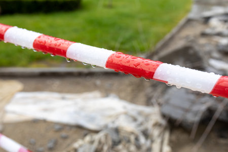 Striped boundary tape blocks the passage before road repair work. selective focus.の写真素材
