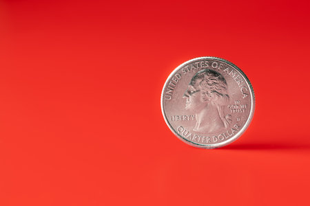 Unites States coin quarter dollar on a red background. Copy Spaceの写真素材