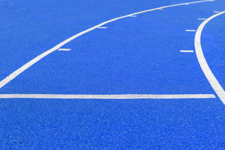 Protective coating on the treadmill with white markings. Turn of the track and mark 10 meters. Rubber coating for playground or sports activity. Padded floor covering with rubber granules.の写真素材
