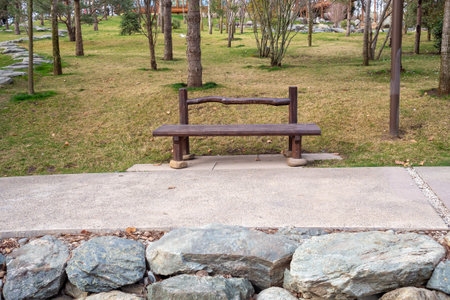 Traditional bench setup for urban park use. Stones in foreground, Japanese garden. Basic principles of landscape furnishing and civic space planning.の写真素材
