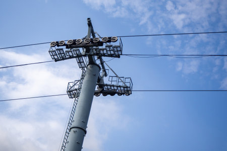 Support tower of mountain cable car against blue sky. Alpine transport infrastructure. Tall metal...