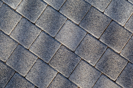 Gray paving stone texture, square blocks forming urban walkway surface. Close-up of concrete pavement tiles for construction and design use. Architectural background. Photoの写真素材