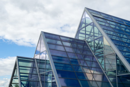 Contemporary architecture with transparent panels and steel. Glass roof of modern building with triangular structure. Real photoの写真素材