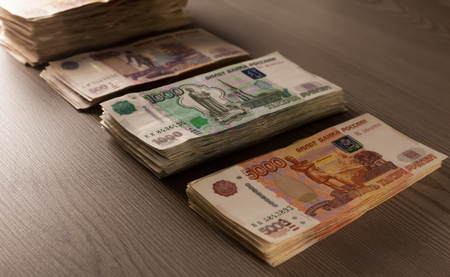Money. Russian rubles on a wooden background. Bundles of moneyの写真素材