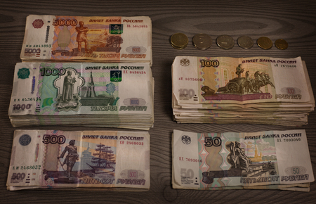Money. Russian rubles on a wooden background. Bundles of moneyの写真素材