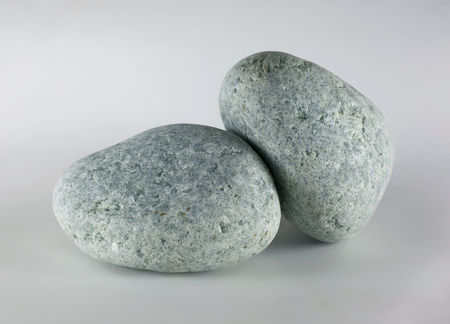 Two pebbles stone isolated on white background. Jadeite stone.の写真素材